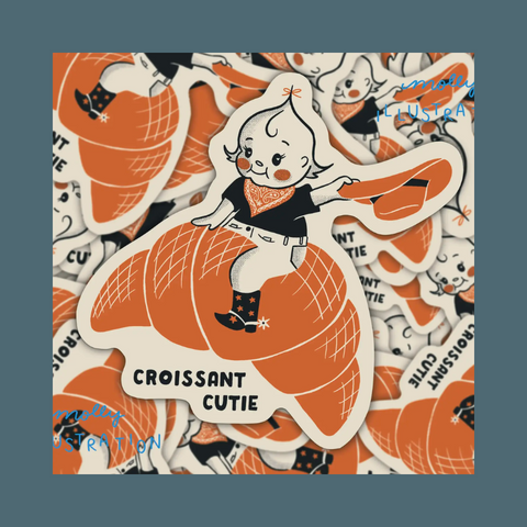 Kewpie riding a croissant