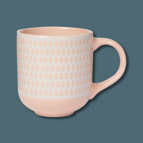 Light peach mug with light peach raindrops on white background