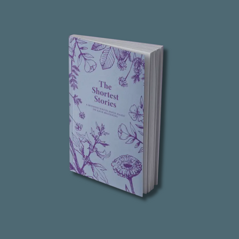 Book titled 'The Shortest Stories' with floral design on a gray background