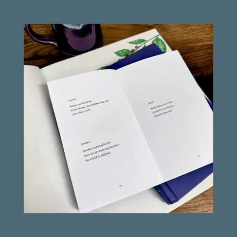 Open book with text on a wooden surface with a mug in the background