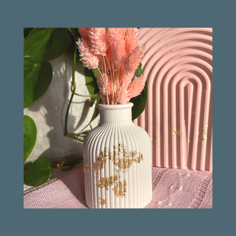 White vase with gold leaf