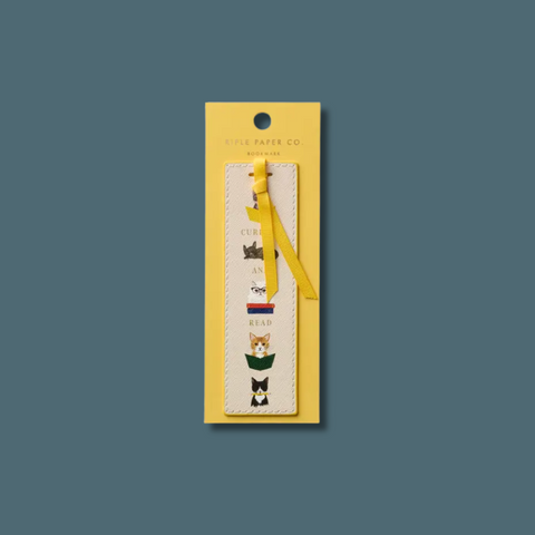 Bookmark with cat illustrations on a yellow card against a dark blue background