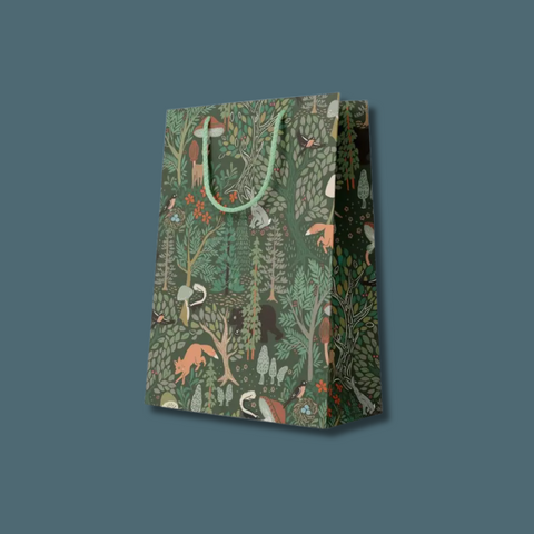 Gift bag with forest animal pattern on a solid background.