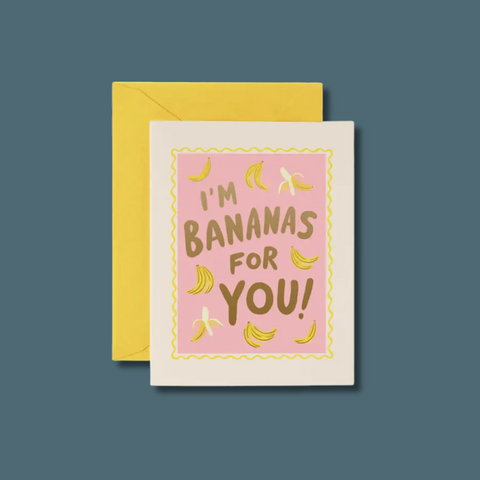 Greeting card with 'I'm Bananas for You!' text and banana illustrations on a pink background, with a yellow envelope.