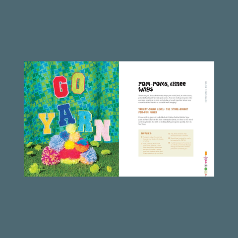 Magazine or book page with colorful yarn and pom-poms on a grassy background