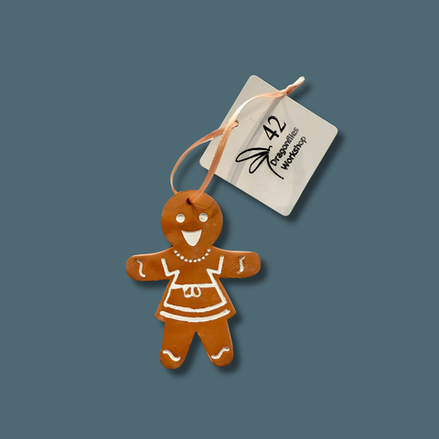 Gingerbread man ornament with a tag on a blue background