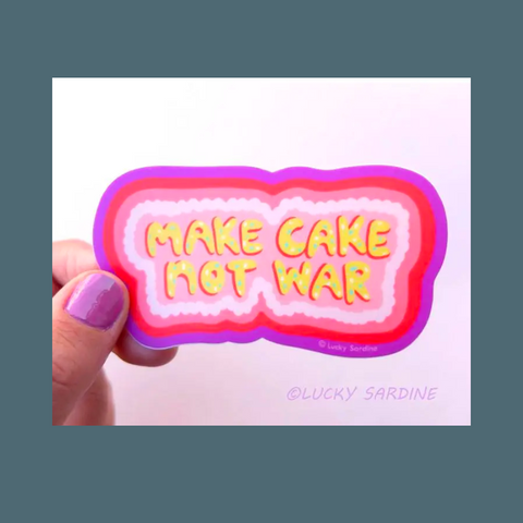 Yellow cake text among pink icing