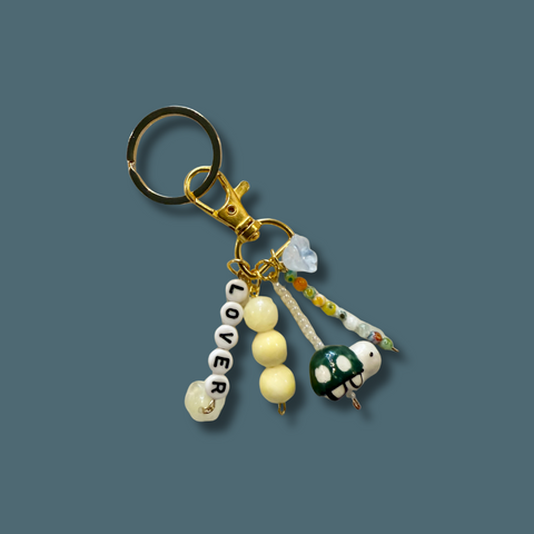 Keychain with decorative elements on a solid background