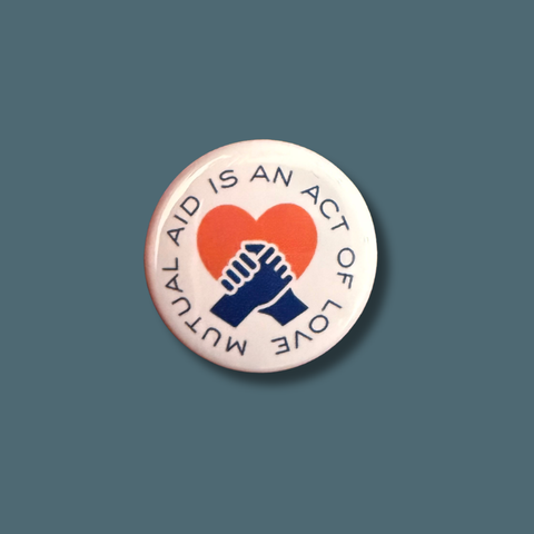 Button badge with a heart and hands design on a blue background