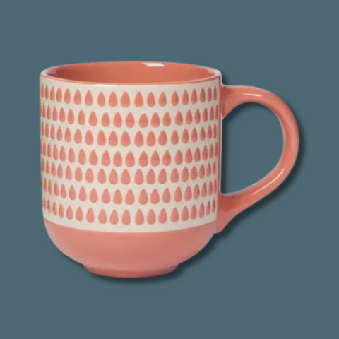 Peach mug with peach raindrops on white background