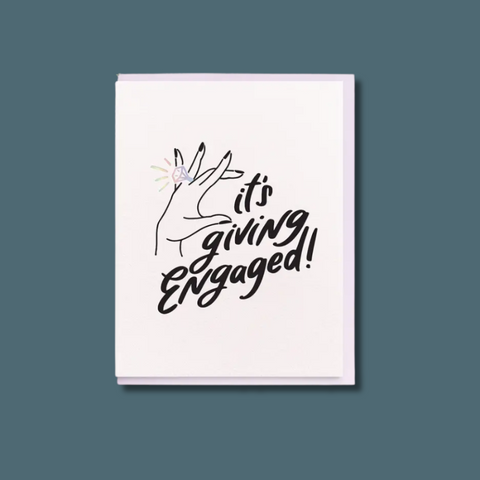 Card with 'it's giving engaged!' text and hand holding a ring on a white background