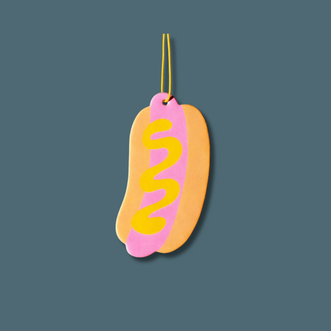 Pink hot dog with mustard on it