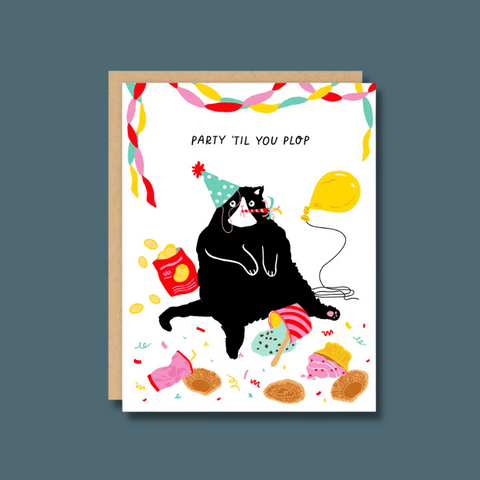 Cat with junk food and party things around